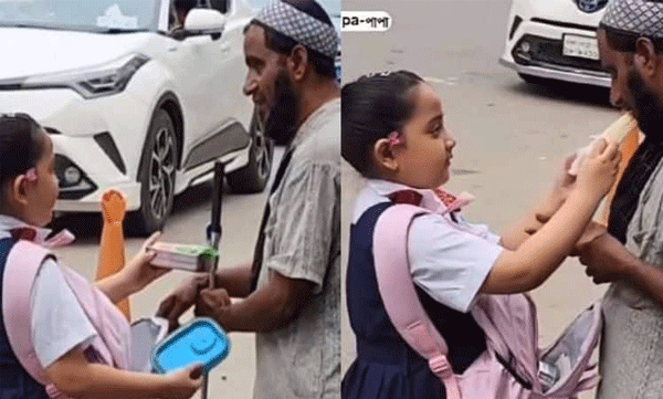 ഉച്ചഭക്ഷണ പൊതിയിൽ നിന്ന് പാതി ഒരു യാചകന് പകുത്തു നൽകുന്ന  വിദ്യാർത്ഥിനി 
