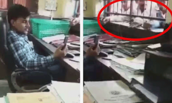 മുന്നില്‍ അക്ഷമരായി ക്യൂ നില്‍ക്കുന്ന ആളുകള്‍: കസേരയില്‍ ഇരുന്ന് വീഡിയോ കോളില്‍ മുഴുകി സര്‍ക്കാര്‍ ഉദ്യോഗസ്ഥന്‍, വീഡിയോ 
